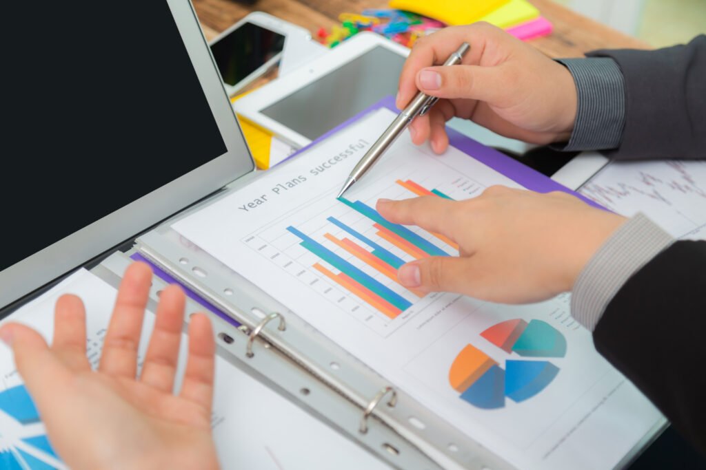 business people meeting at office, business people analyzing bar chart with pen